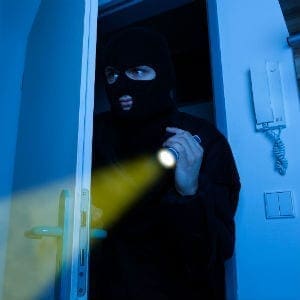 Thief holding flashlight